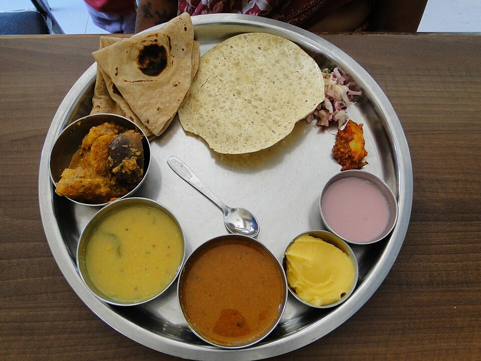 A vegetarian thali with dal, rice, vegetables and flatbread