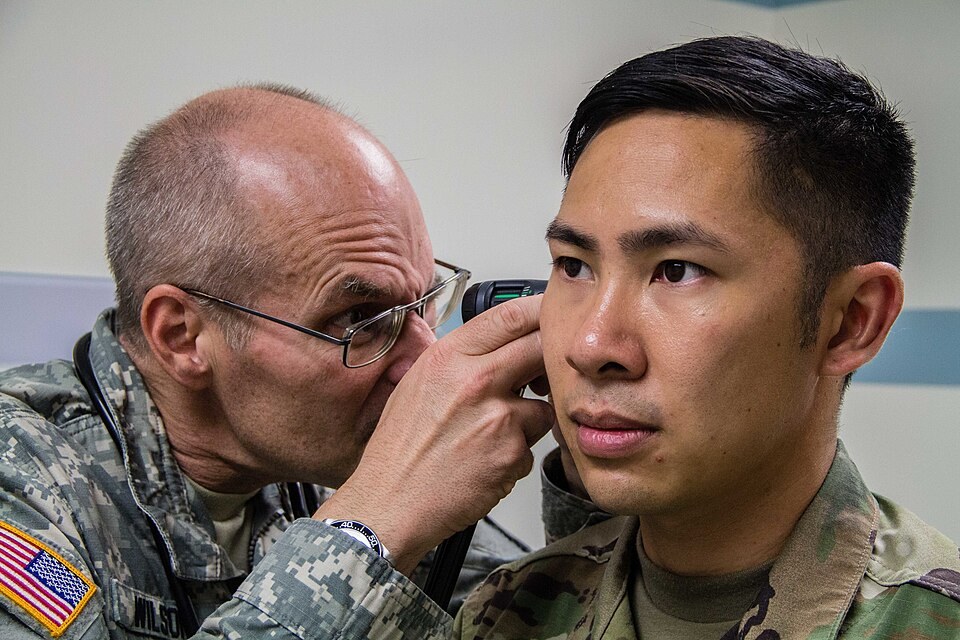 A doctor examining a patient's ear