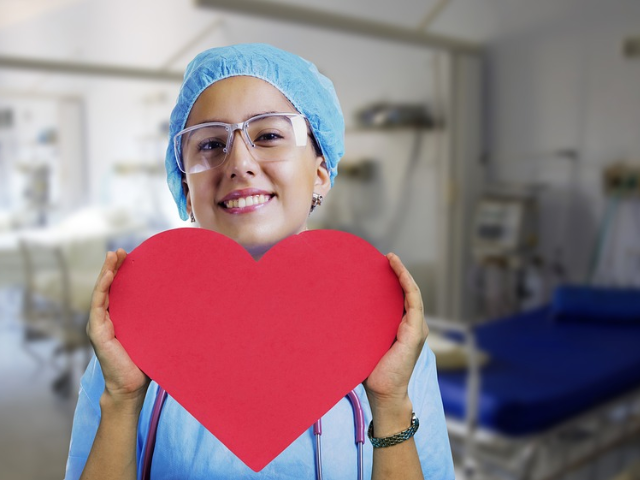 nurse holding a big red heart