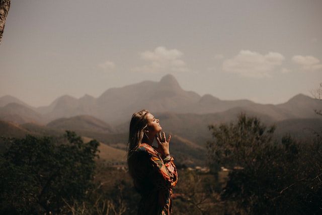 woman in jacket standing on green grass