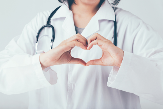a doctor making the heart sign