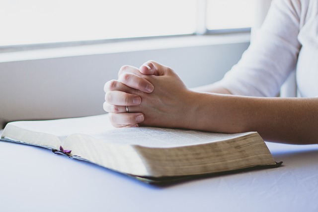 hands on top of a bible