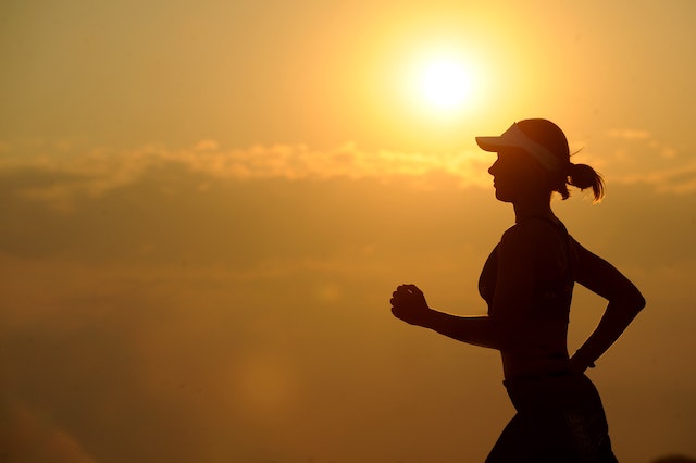 silhouette of a woman on her morning jog
