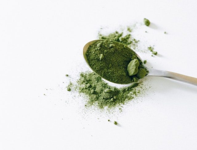 green kratom powder on a spoon