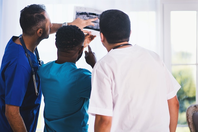 medical professionals examining an xray image
