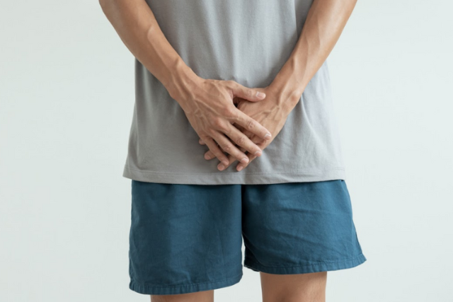 guy covering his lower frontal part - featured image