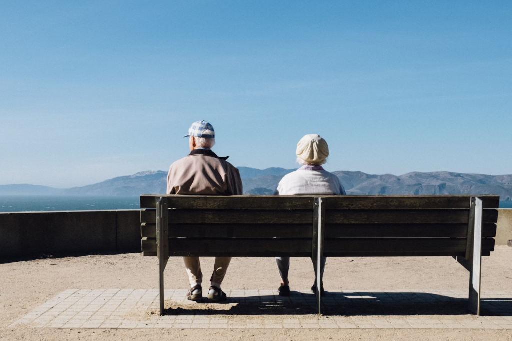 an old couple sitting on a bench